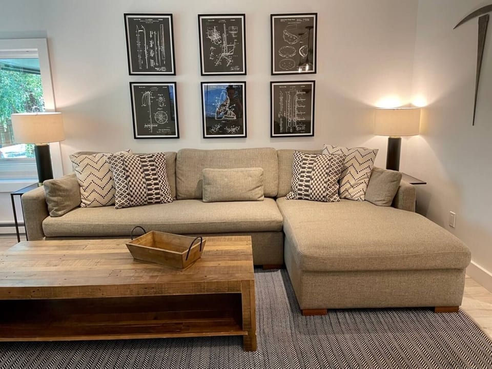 Spacious inviting living room filled with natural light. Open the windows and hear the creek rushing by.