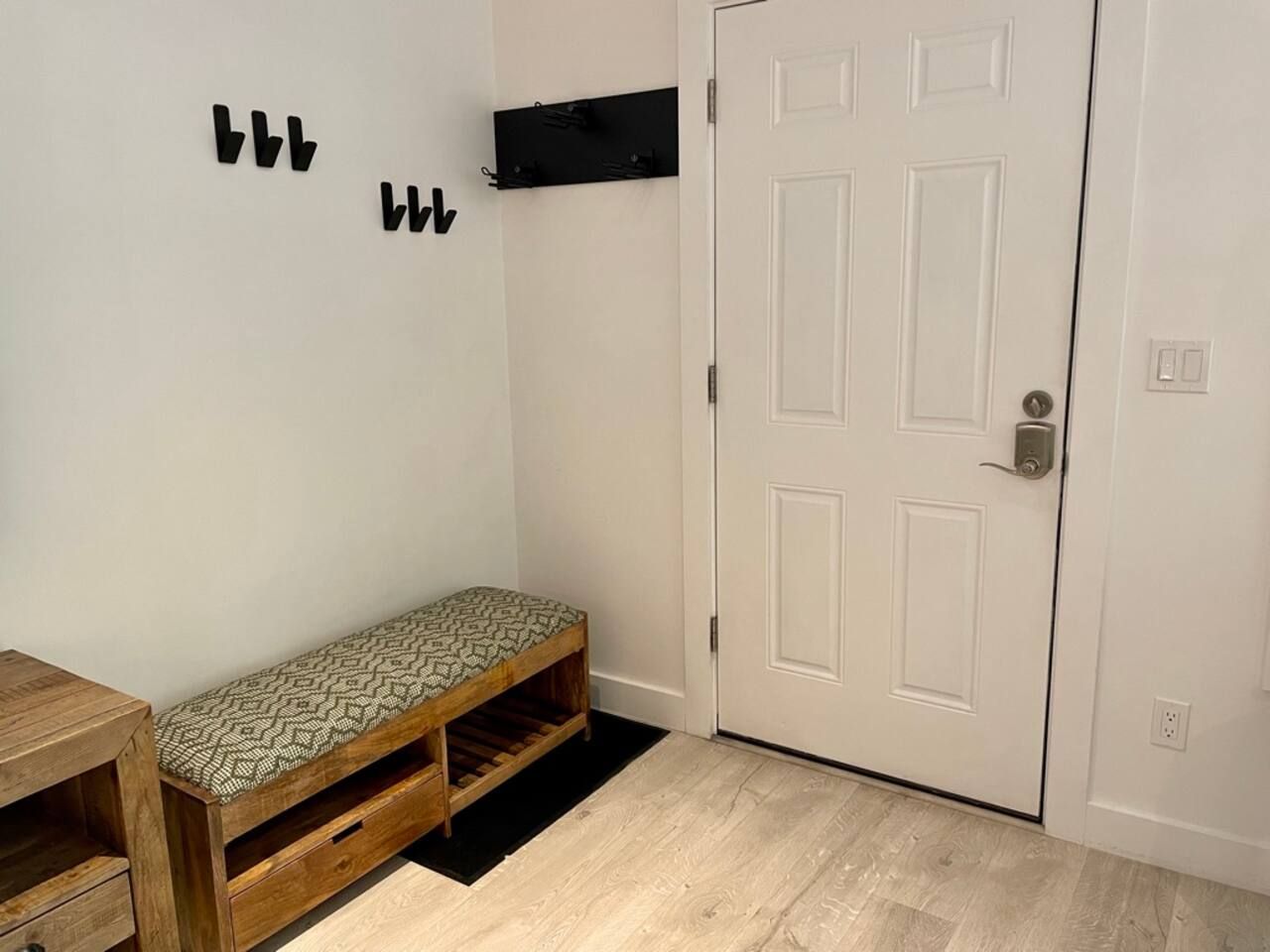 Custom ski rack by front door to hang skis inside the front door