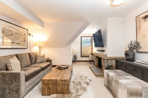 Living room with fireplace and 65" smart tv.