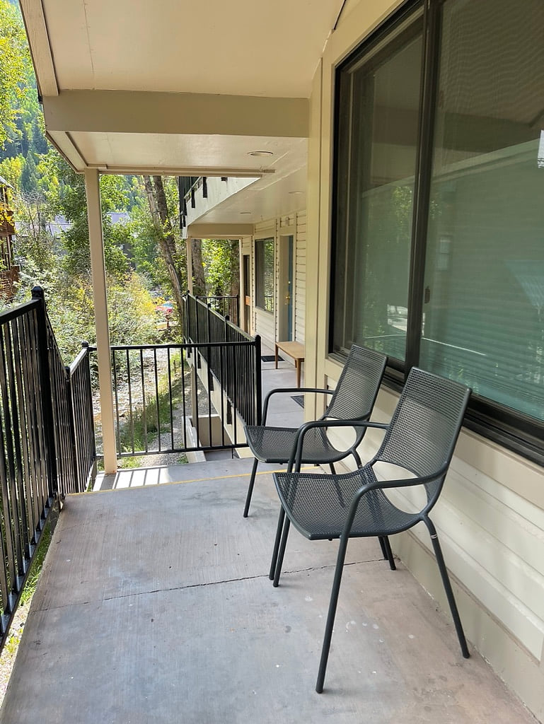 Enjoy listening to the river on the front porch with chairs + small table provided.