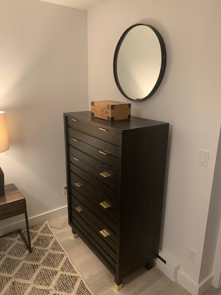 Full sized dresser in bedroom.