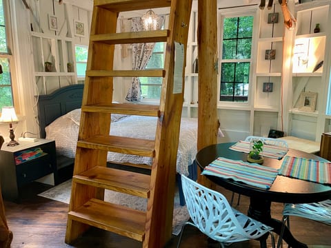 The ladder that leads up to the loft in the treehouse.