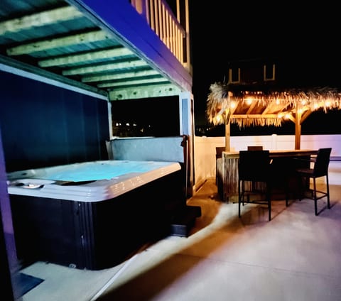 Private Hot Tub and Tiki Bar lit up at night