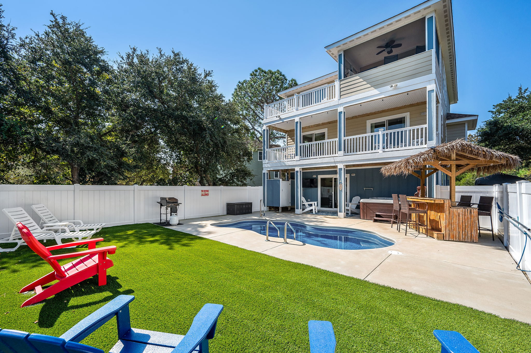 Relaxation at its best: A pool, beach chairs, and a glimpse of the backyard.