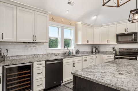 Simplicity and style converge in the white-themed kitchen.