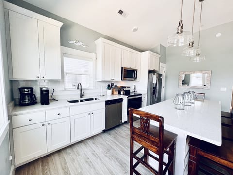 Elegance meets efficiency in this immaculate, well-appointed white kitchen.