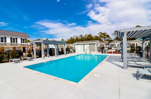 Large Community Pool only steps away, in season use available, expansive deck with more than enough seating for all, covered lounge in table seating provided here