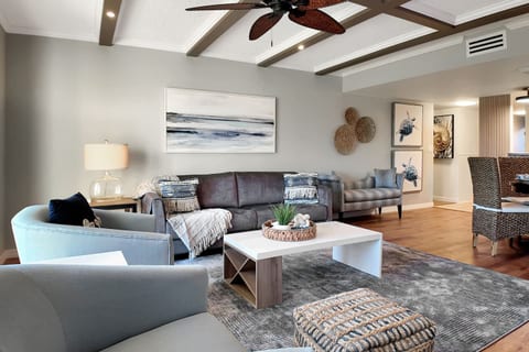 Comfortable living room space with swivel chairs and king mattress sleeper sofa. Spacious at 300 square feet 15’ x 15’ complete with sliding glass door to patio lanai and direct pool access.