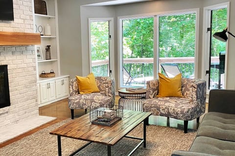 Upstairs Living Room with large windows overlooking Lake Avalon