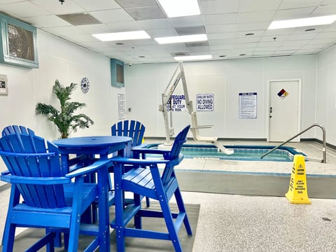 Indoor spa area with pool lift and vibrant seating for year-round relaxation