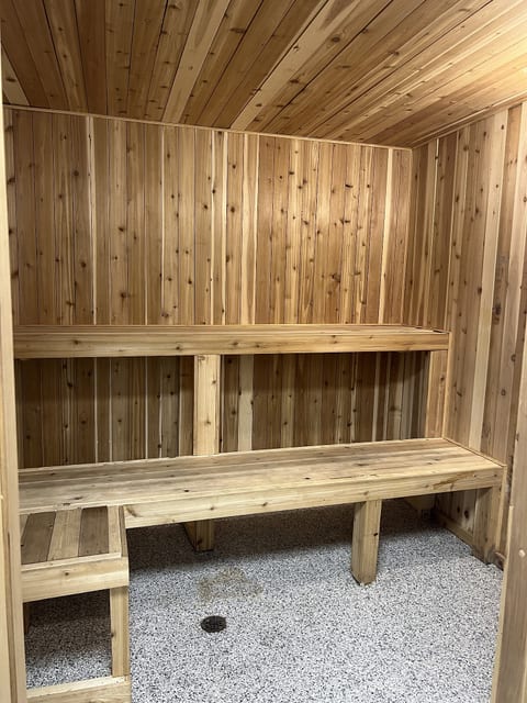 Cozy cedar sauna with built-in benches for a relaxing spa-like retreat