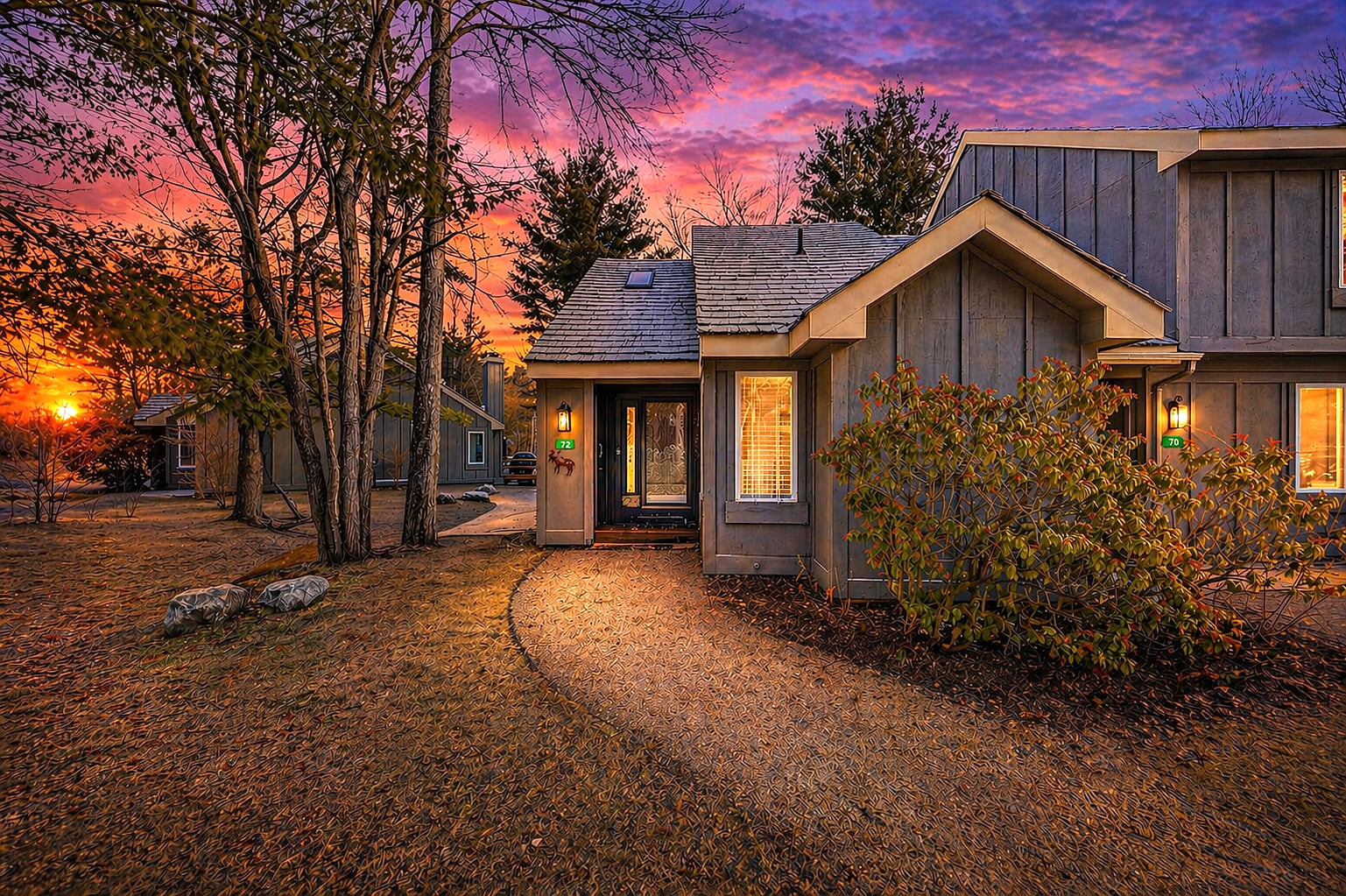 Cozy wooded retreat with warm porch lights and stunning sunset views
