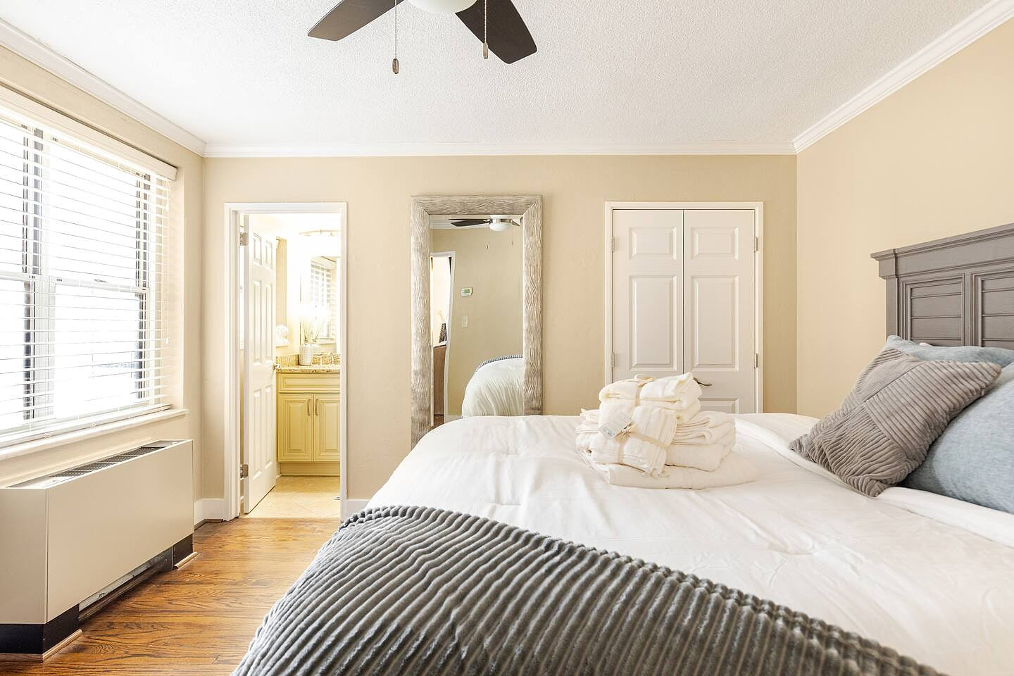 Cozy guest room w/ soft bedding & natural light for a restful stay.