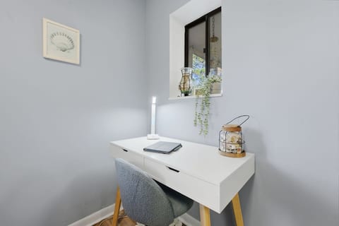 Dedicated workspace just in case you need to check those emails! The desk lamp has a Qi charging station on the base.