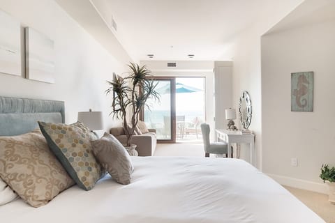 Enjoy the ocean waves right outside your doors in the master bedroom