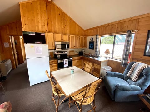 Full Kitchen with fridge, microwave, brand new stove and oven, microwave, table, sitting chair and great views.