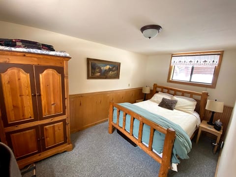 Bedroom with log queen bed. We also have a pack and play available.