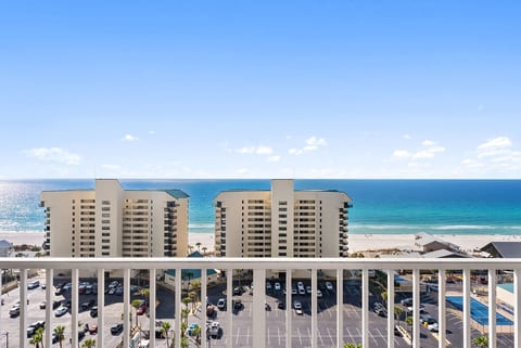 Spacious private balcony with cozy seating and breathtaking Gulf views.