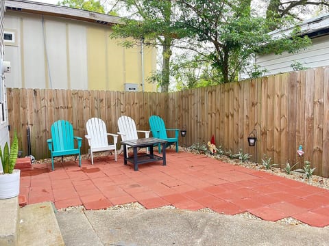 Outdoor Oasis: Relax on vibrant chairs in your private patio, perfect for morning coffee or evening chats!