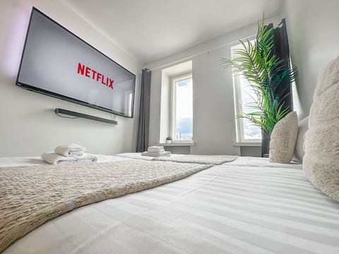 You'll wake up to beautiful views in this penthouse flat! 

The 75" 4k Ambilight Smart TV system has an Android OS, so you may browse the web with it. Best of all, you can watch movies directly from bed.