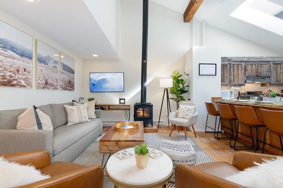 Cozy natural gas fireplace in living room, operable from the thermostat on the wall.