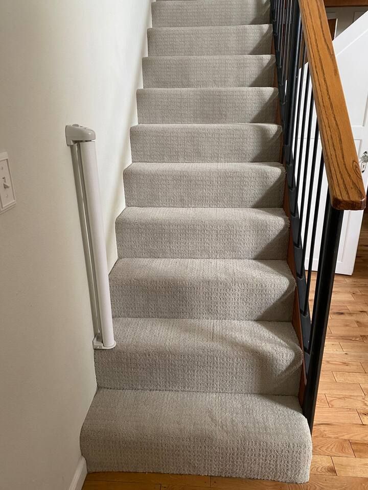 The baby gate can retract or be removed and stored. Simply pull and attach to stair rails on other side via velcro ties.