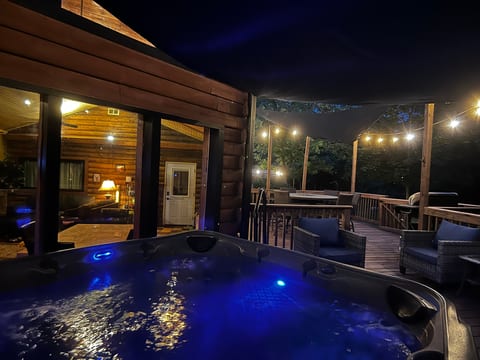 Relax in the 7-person hot tub under the cafe lights at night.