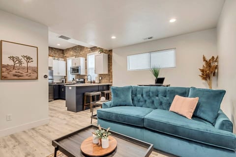 Modern, cozy living space with stylish décor, plush seating, and natural light. Open layout with kitchenette, comfortable sofa, smart TV, and chic finishes—perfect for business travelers or weekend getaways near top attractions
