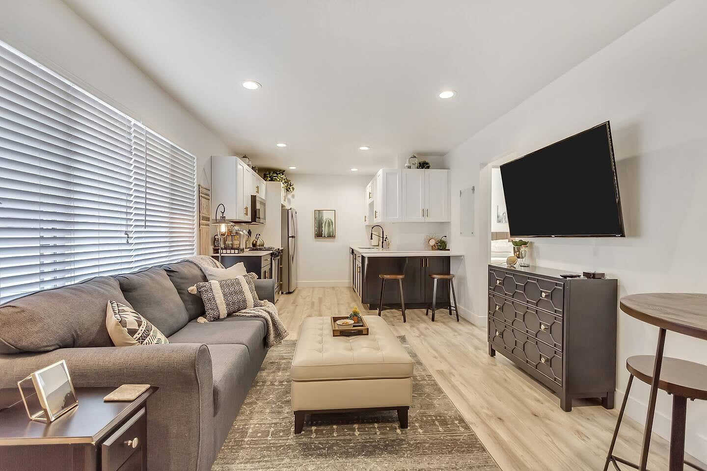 Modern and cozy living space with stylish decor, comfortable seating, fast Wi-Fi, smart TV, and natural light. Perfect for business travelers or couples, featuring an open layout, in-unit laundry, and a prime location close to dining and attractions