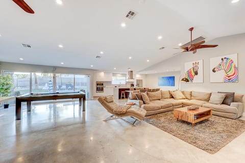 Bright open-concept living room with modern seating and Smart TV