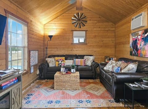 Cozy up in our cabin's living space where rustic charm meets homely comforts for those perfect indoor moments.