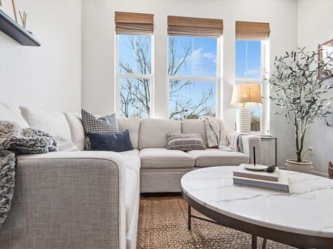 Oversized sectional, smart TV, and plenty of natural light.