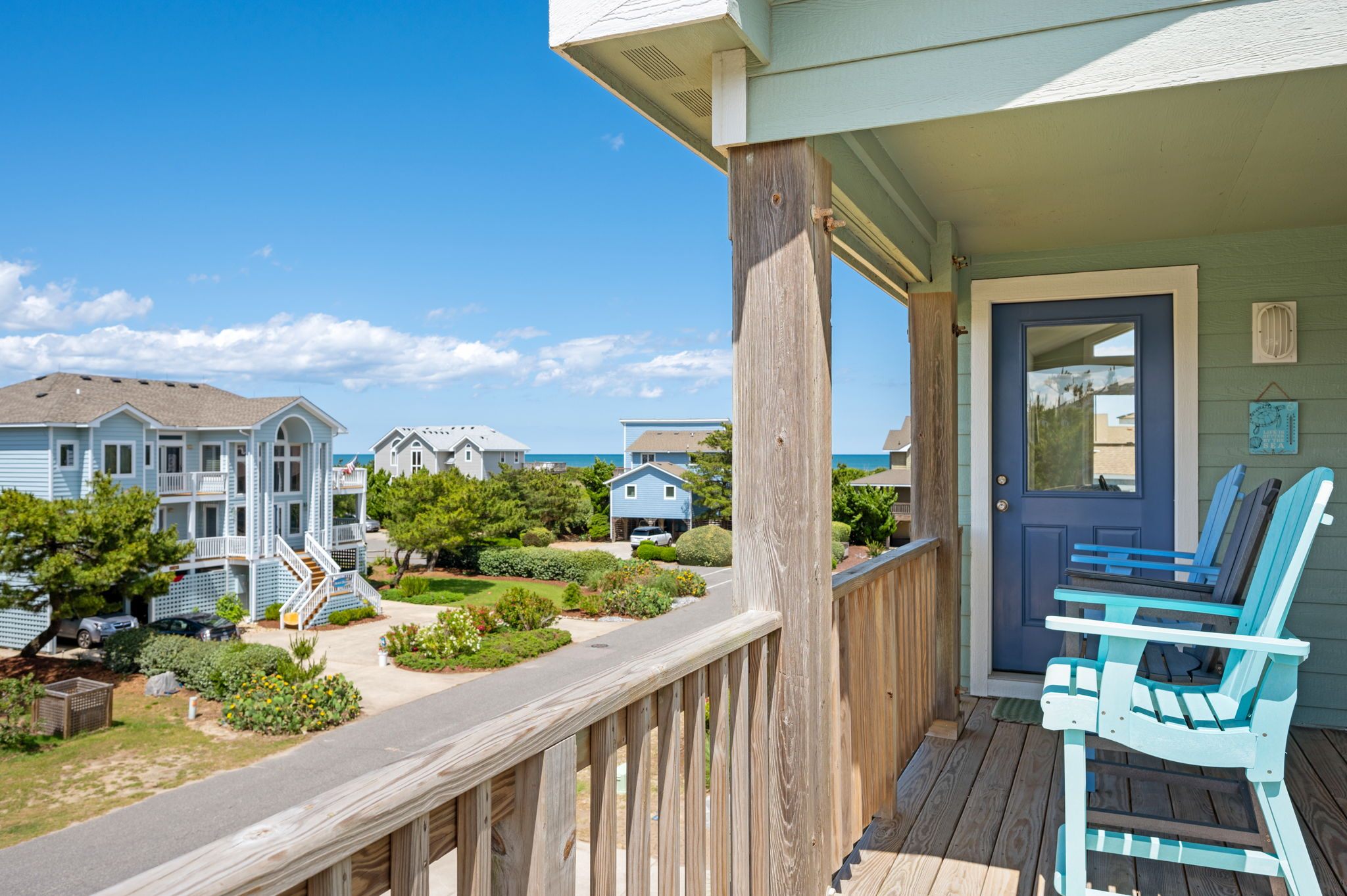 North deck with ocean views, pub chairs for 3, 3 rocking chairs, and picnic table.