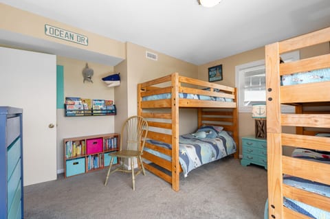Bunk room with a kids' library and toys
