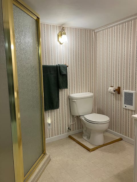 Shower, sink/cabinet and toilet. Bath and shower mats provided. 6-pc. towel set in bath. Extra towel sets available on nearby shelves and hangers.