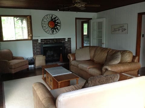 Living room with TV & wood burning fireplace