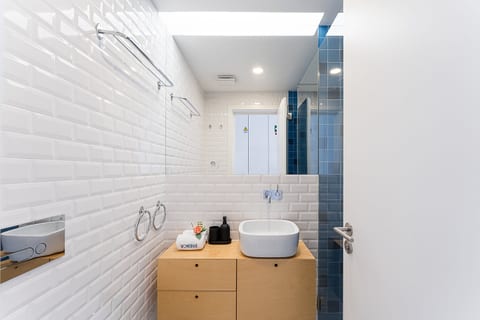 Bright modern bathroom with chic vessel sink and stylish tiled shower