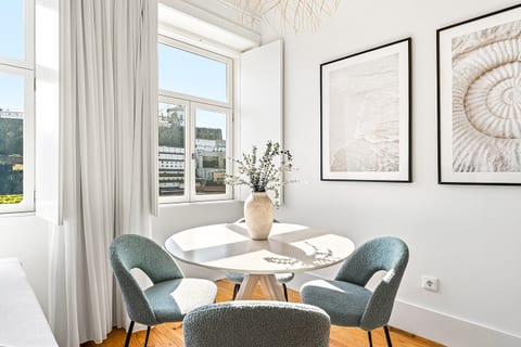 Sun-filled dining nook with city views and elegant coastal decor