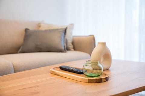 Bright, minimalist lounge with cozy sofa and stylish wood table