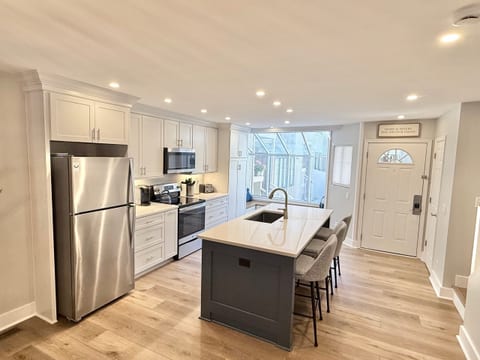Upon entering, you are welcomed into our newly renovated kitchen and open-concept first floor. Enjoy the sunny atrium with built-in window seats. Quartz countertops, full-size pantry, and upgraded cabinets adorn this fully appointed-kitchen.