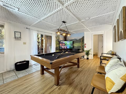 Billiards Room: Unwind in style with a pool table, sleek decor, and stunning mountain views!