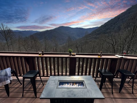 Savor mountain views by the fire with drinks in hand—perfect for sunset memories!