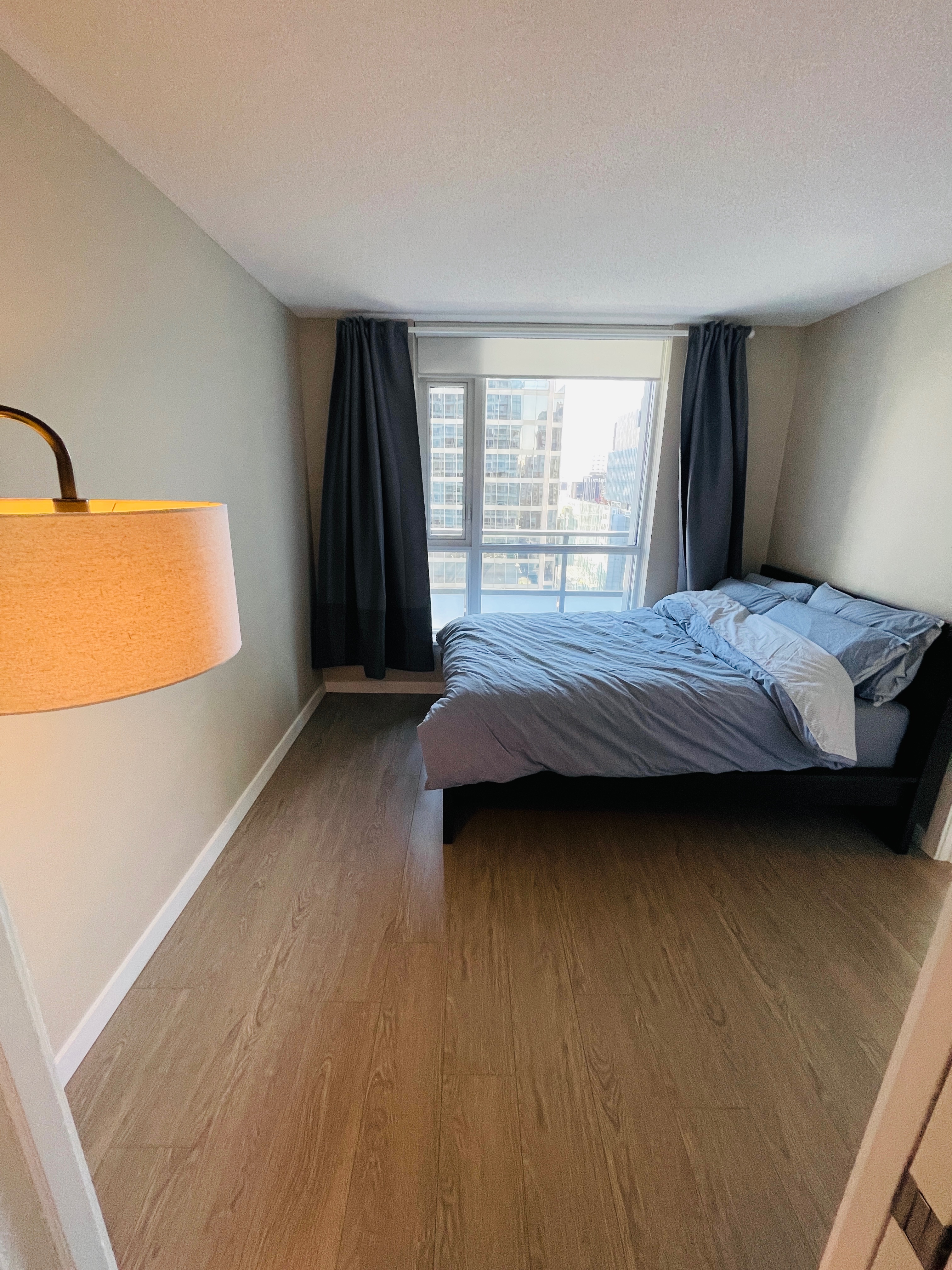 "Cozy bedroom featuring a premium Queen-size Casper bed, a spacious dresser, and a private walk-in closet for ample storage."