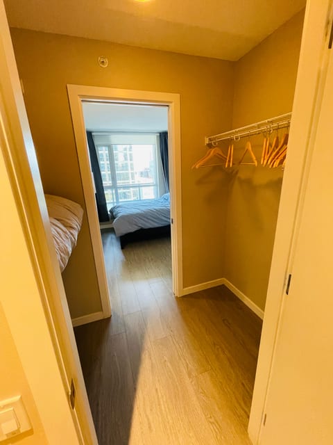 "Spacious walk-in closet with ample hanging space and shelving, offering plenty of room to store all your luggage and belongings."