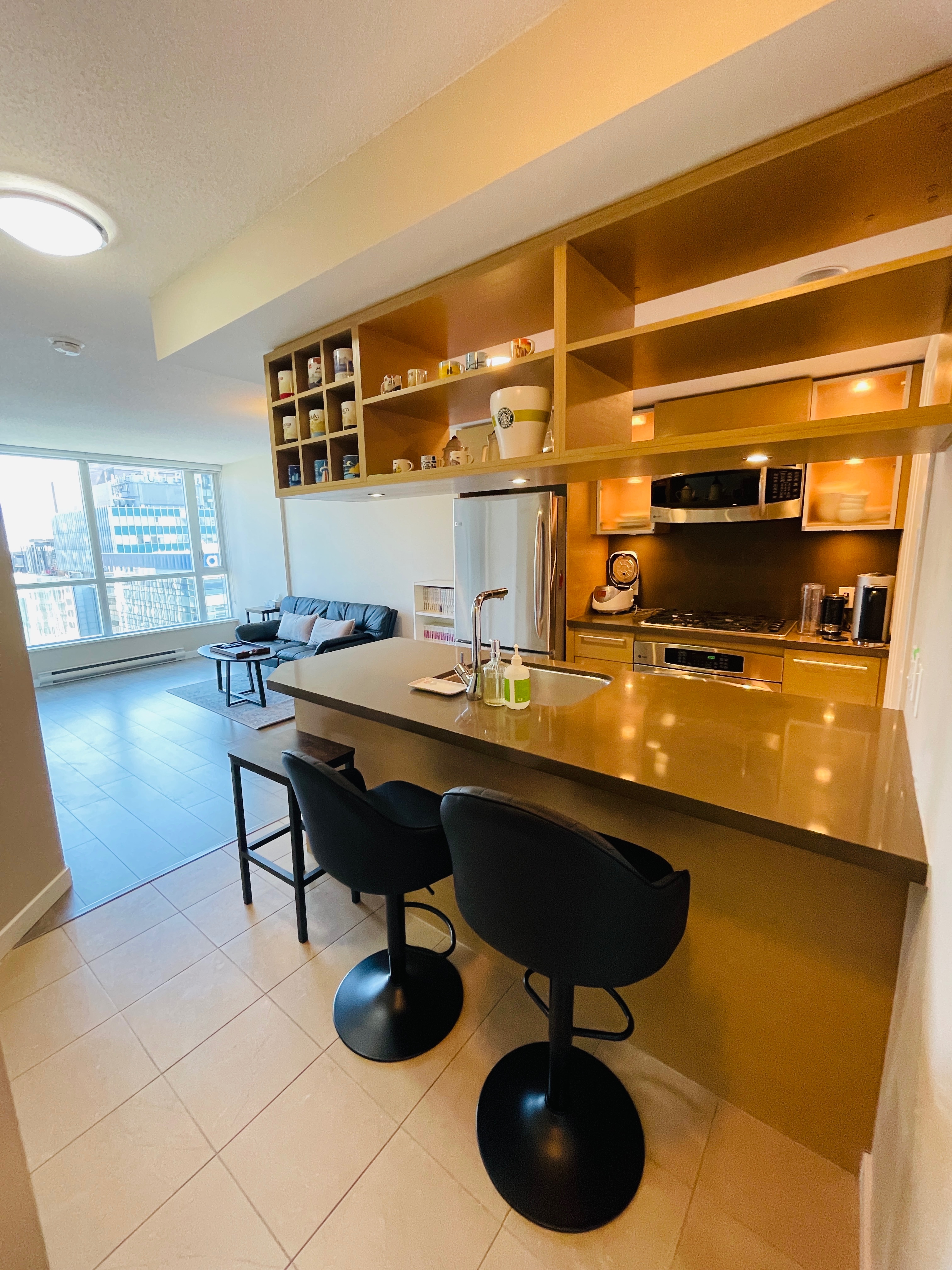 "Modern open-concept kitchen with a stylish breakfast bar, premium appliances, and a seamless flow into the bright living area."