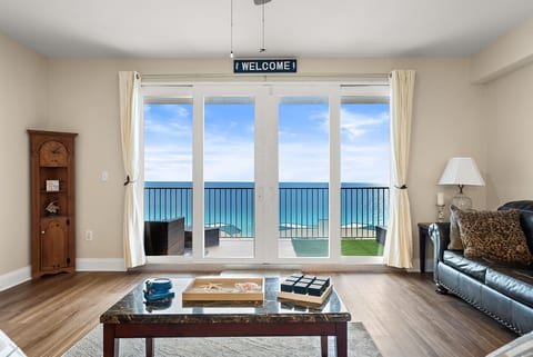Enjoy stunning panoramic Gulf views from the living room’s expansive sliding glass doors