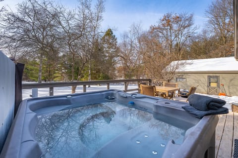 Private hot tub and deck seating in a peaceful winter backyard retreat