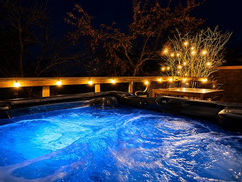 Private hot tub with glowing lights for cozy evenings on the deck