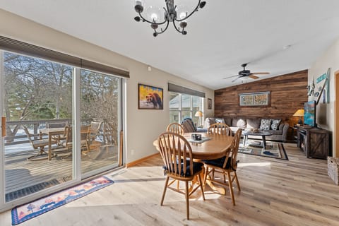 Bright open living space with deck access and cozy rustic charm