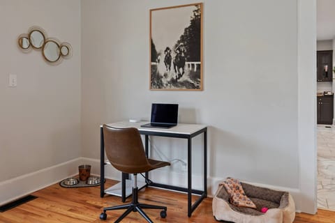 Stay productive and relaxed with a dedicated workspace featuring a leather office chair and a cozy corner swivel chair, perfect for work or unwinding.